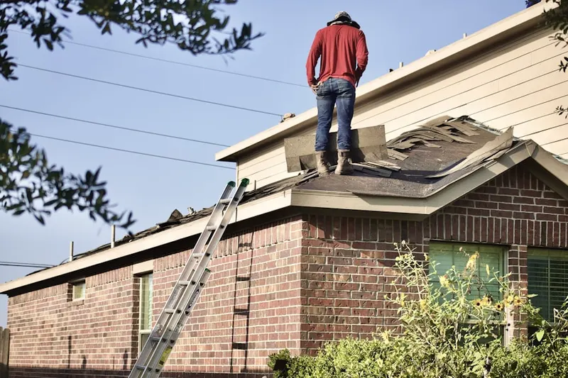Professional roofer working on a residential roof in Bigger Tract